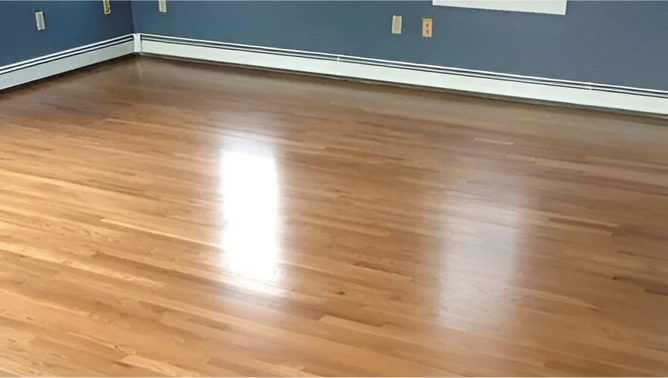 A room with hard wood floors and blue walls.