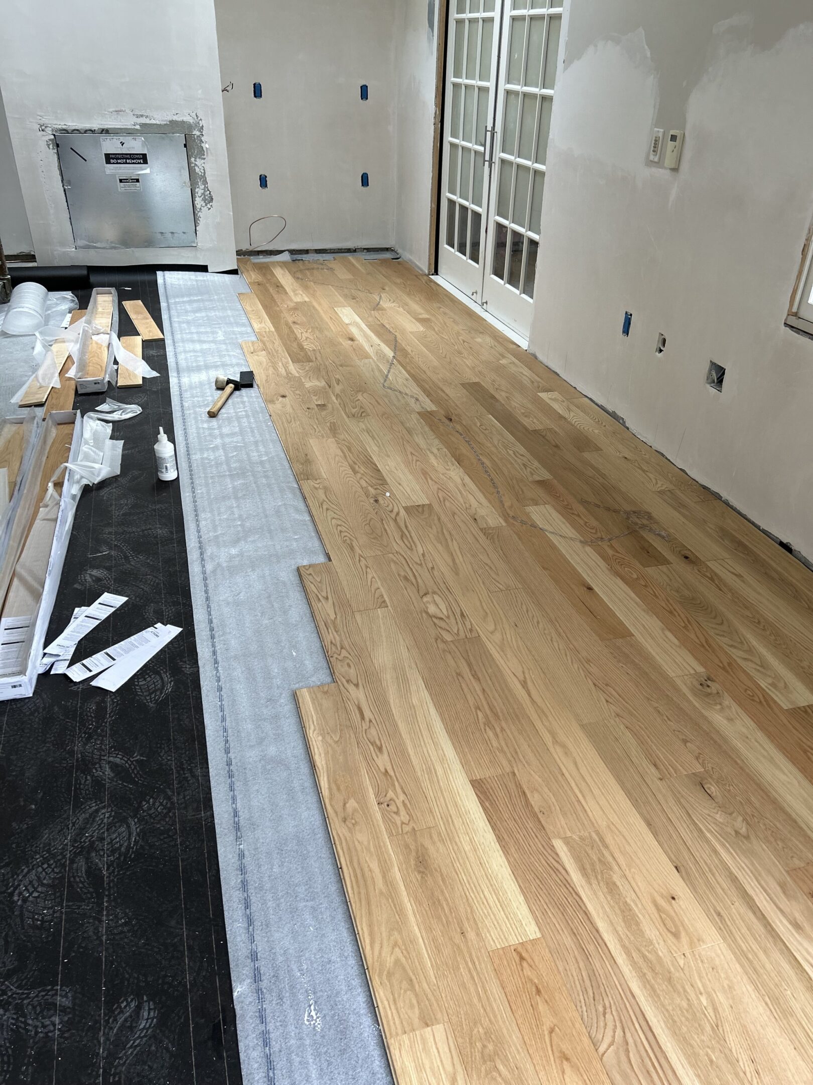 A room with wood floors and tile flooring.